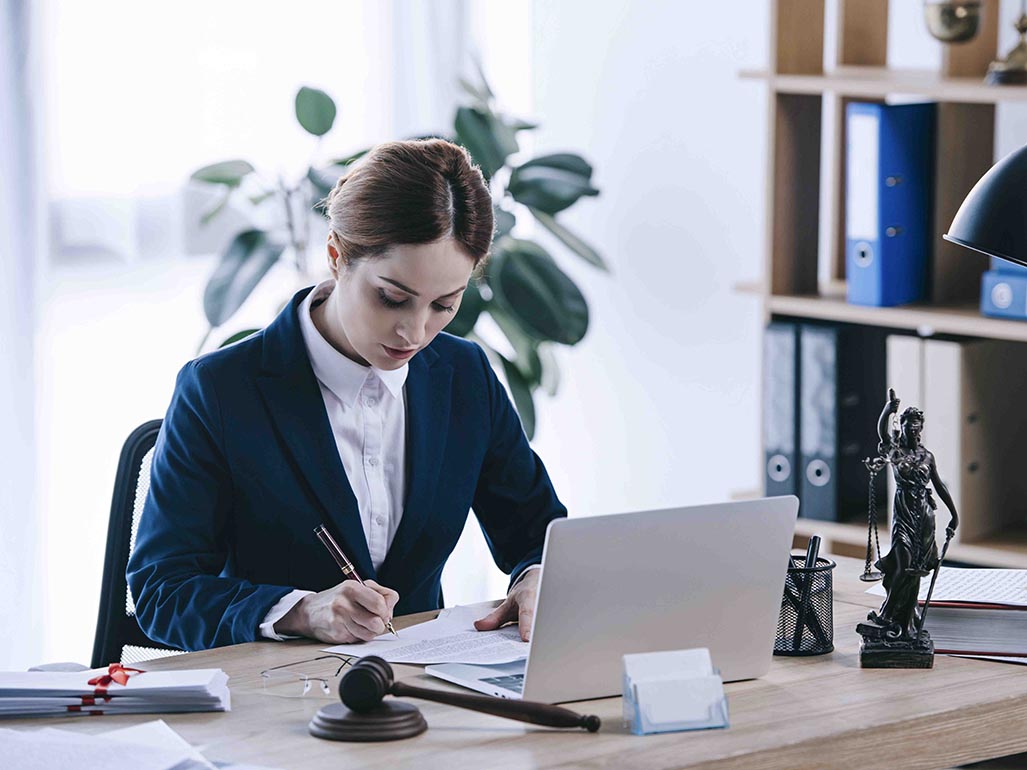 Lawyer writing at desk